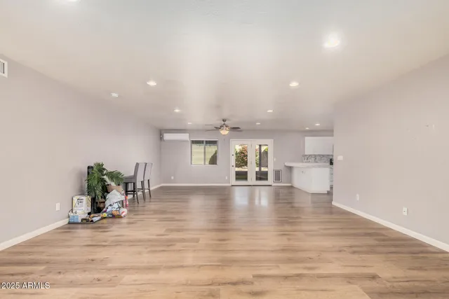 a view of a living room and kitchen with furniture wooden floor and window