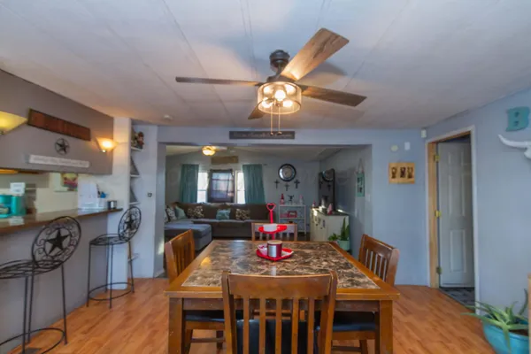 a view of a dining room with furniture wooden floor and chandelier
