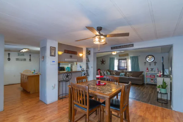a dining room with furniture and wooden floor