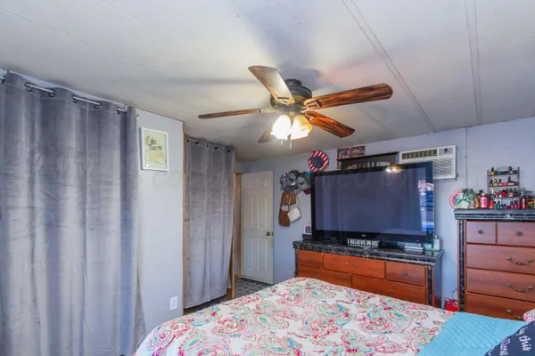 a bedroom with a bed and a flat screen tv