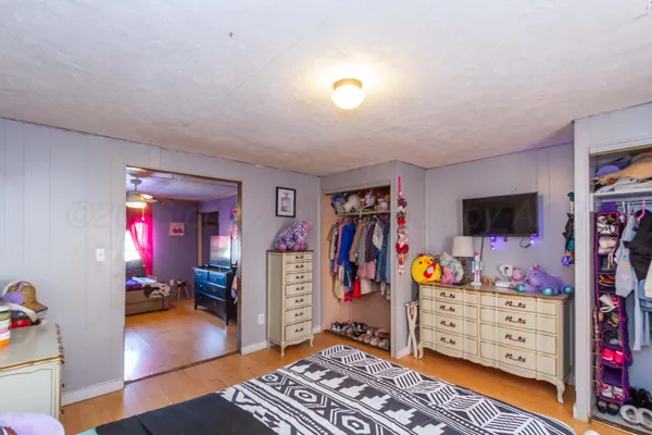 a view of a livingroom with furniture and bedroom view