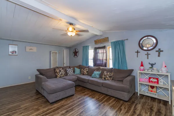 a living room with furniture and a wooden floor