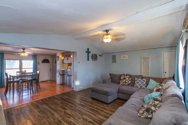 a living room with furniture and wooden floor