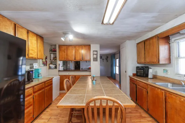 a kitchen with stainless steel appliances microwave stove refrigerator sink and cabinets