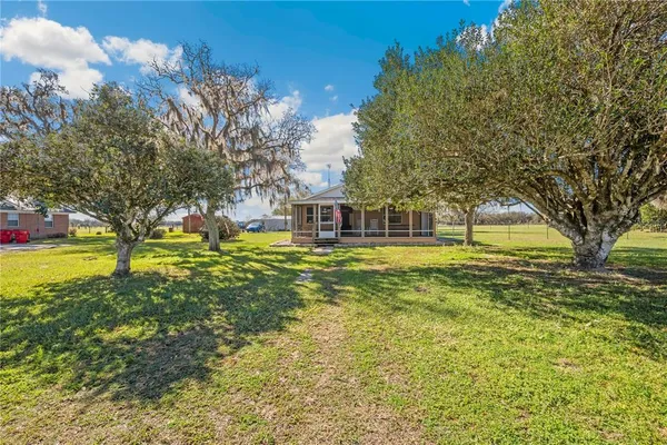 a swimming pool with trees in the background