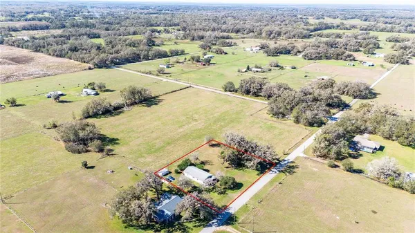 an aerial view of a house with a lake view