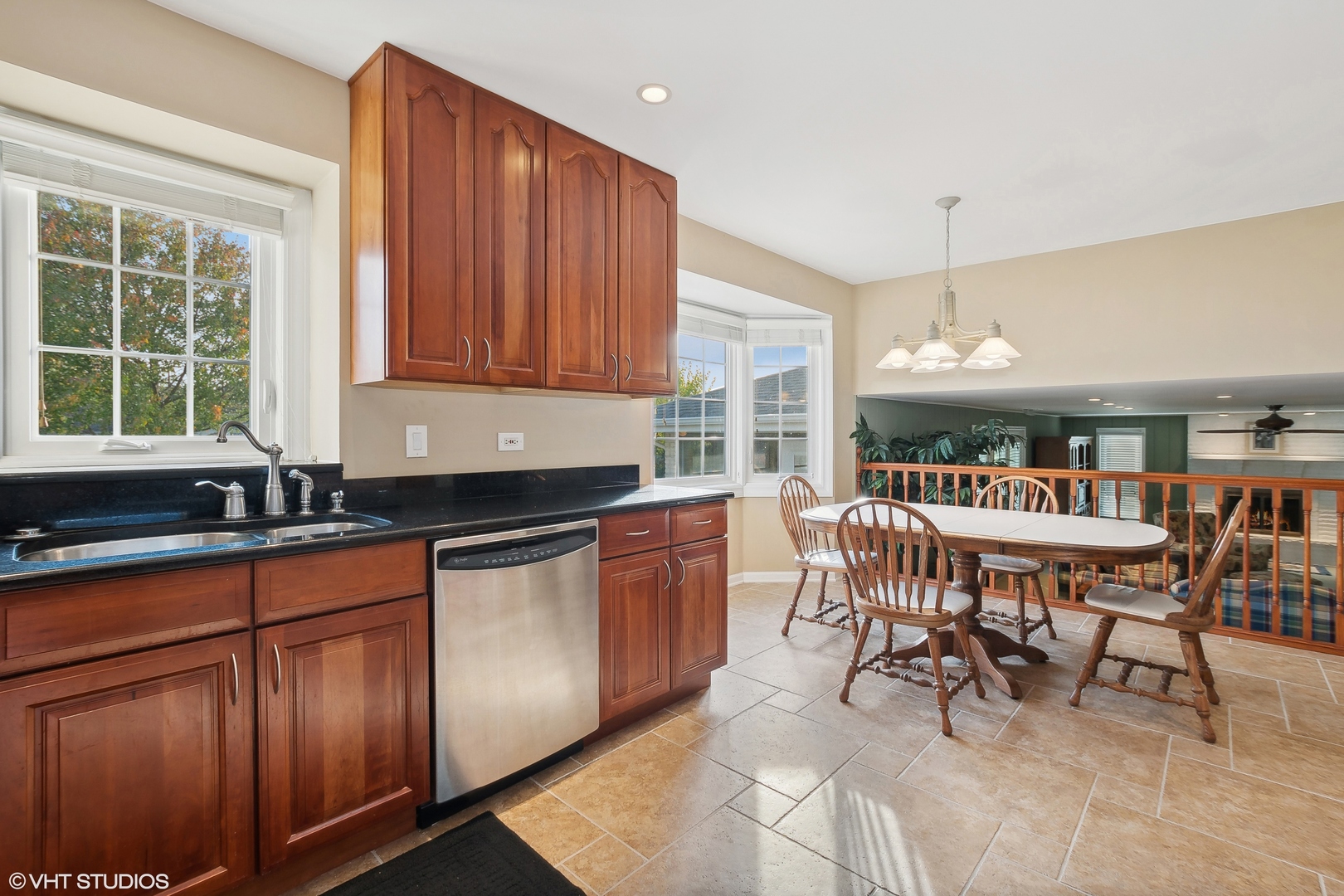 8669 Raintree Lane Orland Park, IL 60462 - Photo 8 of 25 a kitchen with stainless steel appliances granite countertop a table chairs and a sink