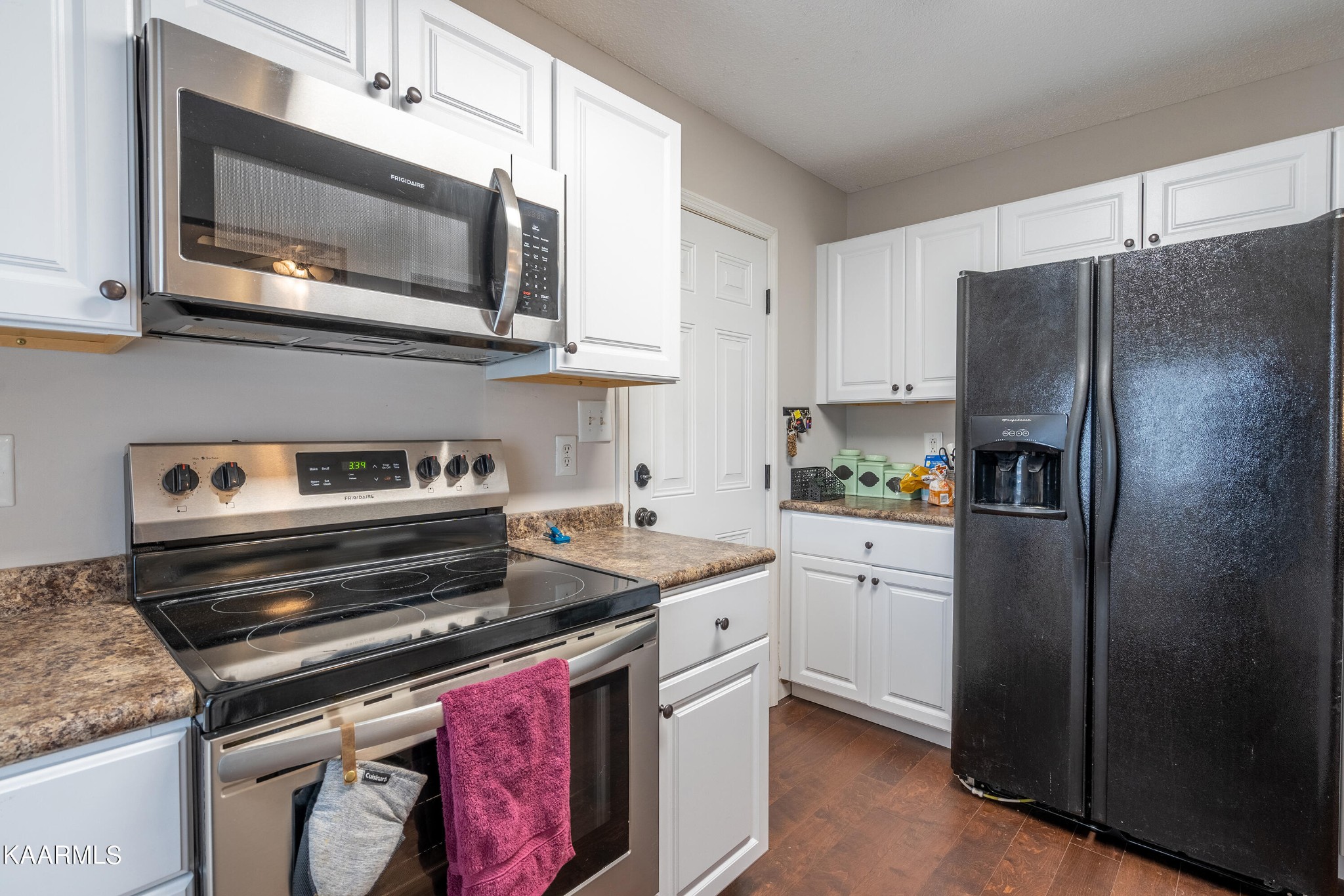 6408 Wilmouth Run Road Knoxville, TN 37918 - Photo 12 of 29 a kitchen with stainless steel appliances granite countertop a refrigerator stove and microwave