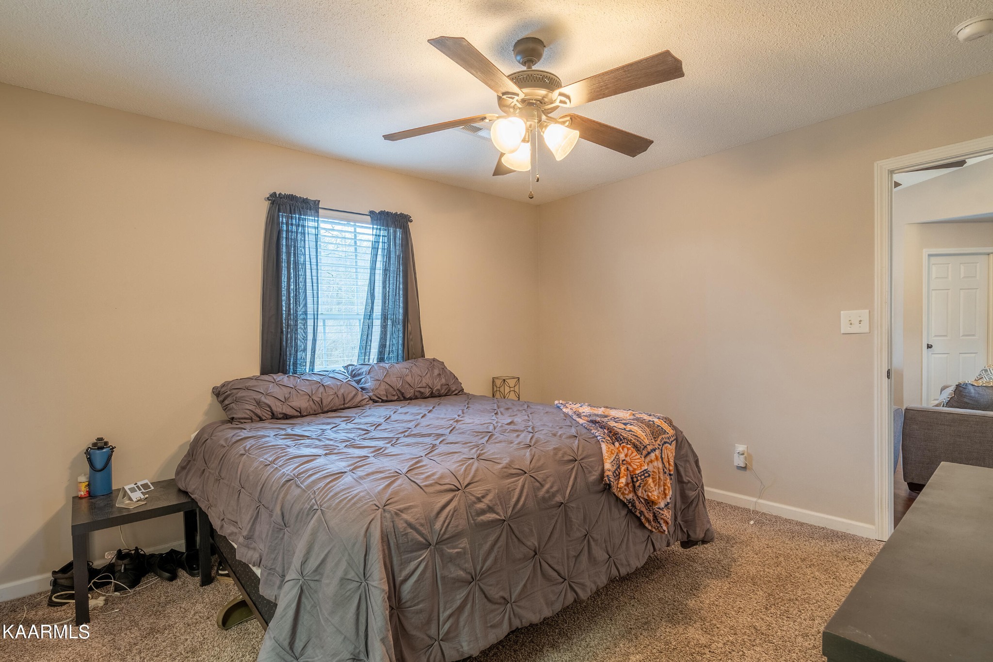 6408 Wilmouth Run Road Knoxville, TN 37918 - Photo 22 of 29 a bedroom with a bed and a chandelier