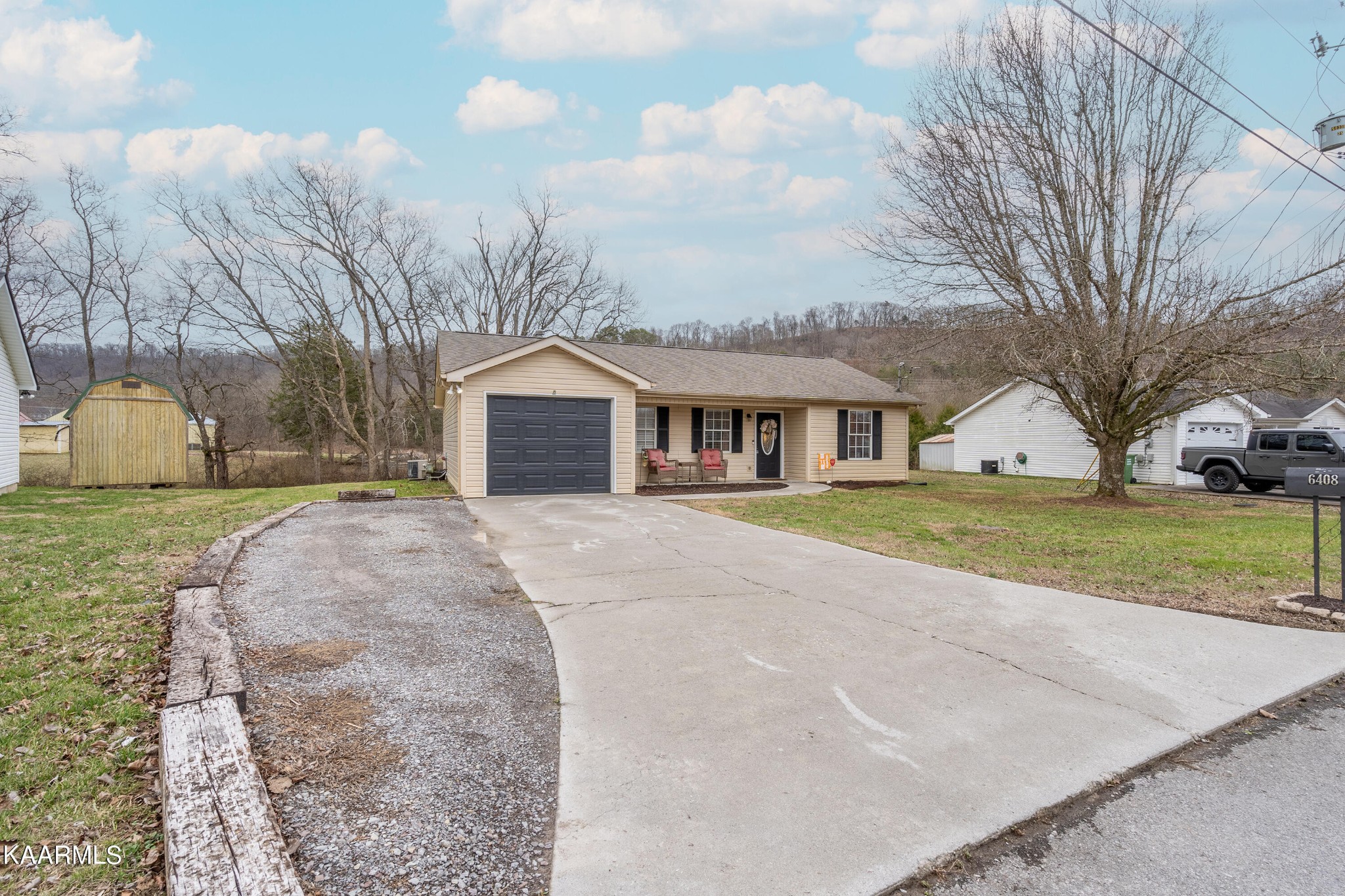 6408 Wilmouth Run Road Knoxville, TN 37918 - Photo 4 of 29 a front view of a house with garden