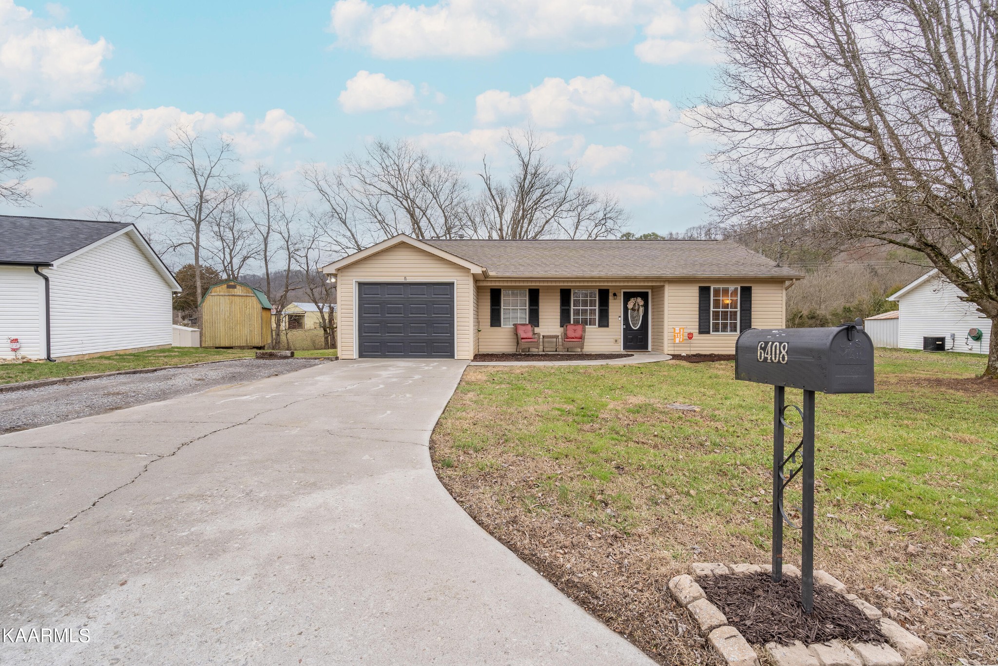 6408 Wilmouth Run Road Knoxville, TN 37918 - Photo 5 of 29 a front view of a house with a yard and garage