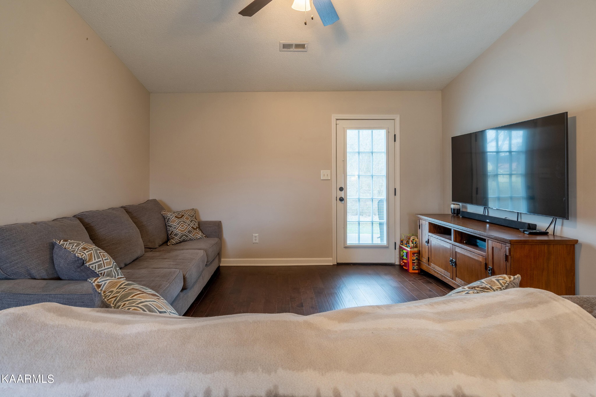 6408 Wilmouth Run Road Knoxville, TN 37918 - Photo 9 of 29 a living room with a couch and a flat screen tv