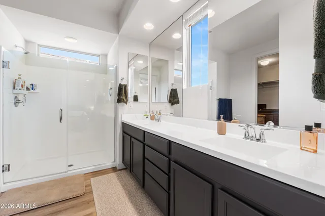 a bathroom with double sink and a mirror