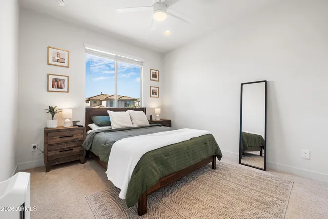 a bedroom with a bed and a painting