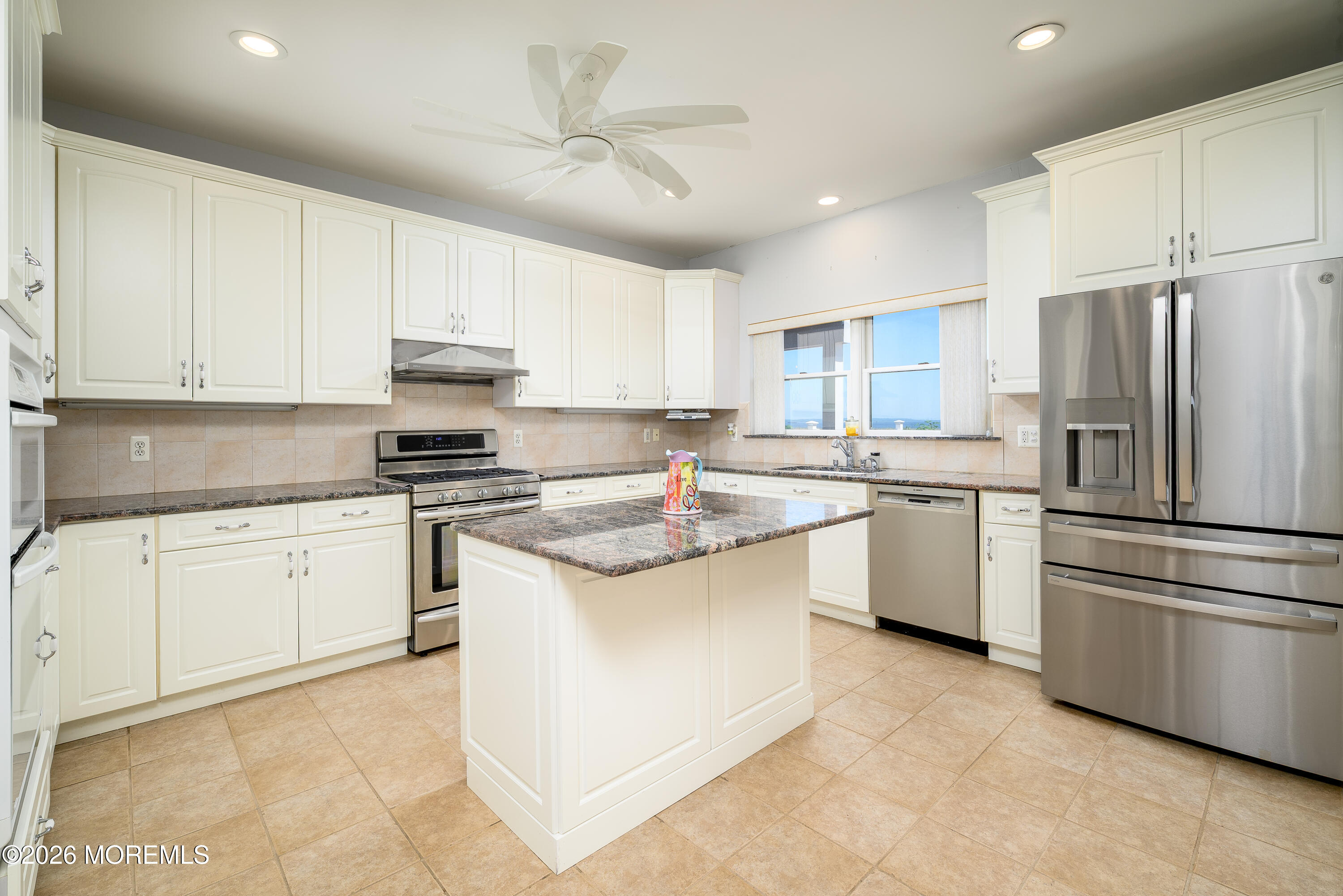 805 Front Street Union Beach, NJ 07735 - Photo 11 of 65 a kitchen with granite countertop a sink stove a refrigerator and white cabinets
