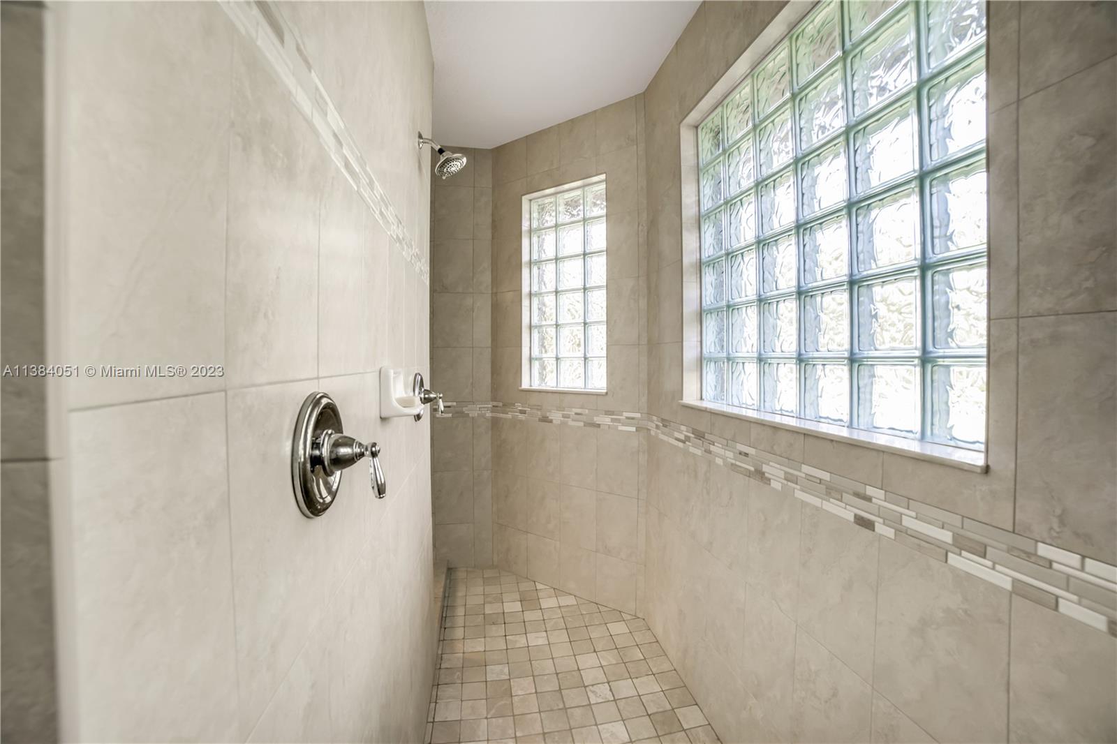 15833 Alexander Run Jupiter, FL 33478 - Photo 12 of 39 a bathroom with a bathtub and shower