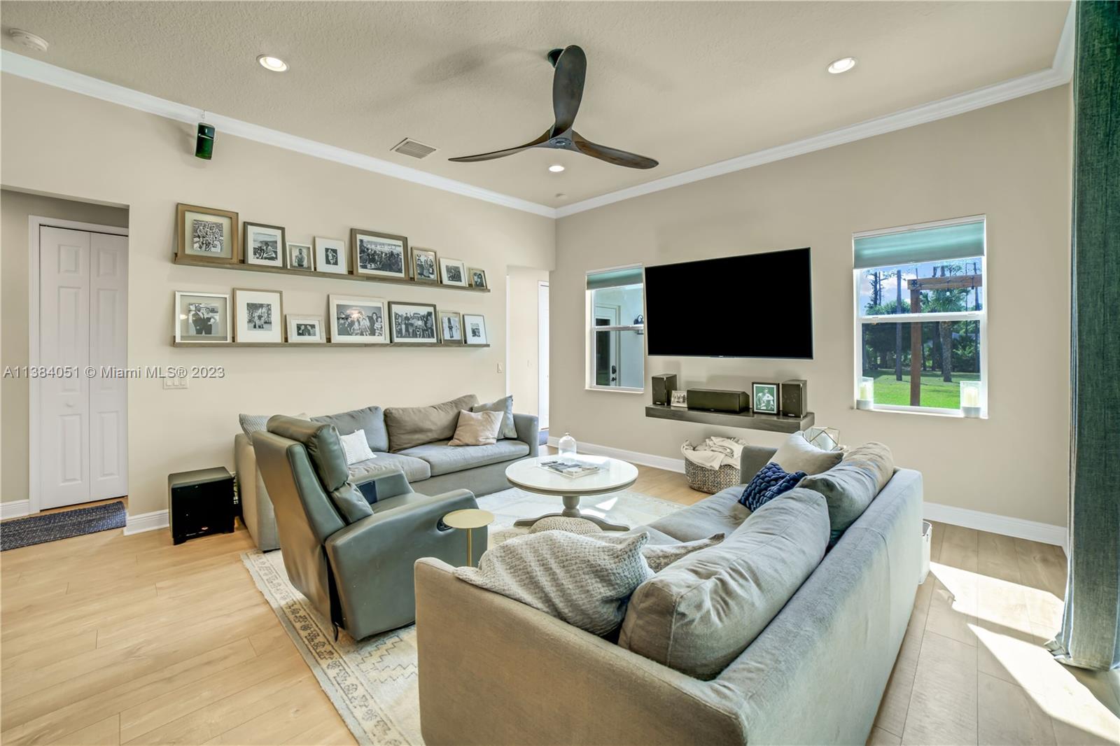 15833 Alexander Run Jupiter, FL 33478 - Photo 16 of 39 a living room with furniture and a flat screen tv