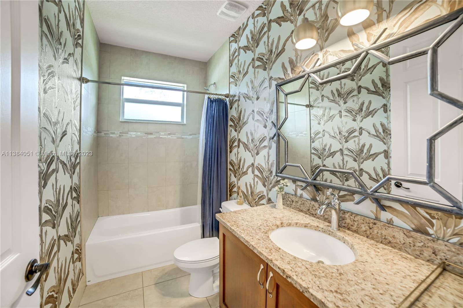 15833 Alexander Run Jupiter, FL 33478 - Photo 20 of 39 a bathroom with a granite countertop sink toilet and shower