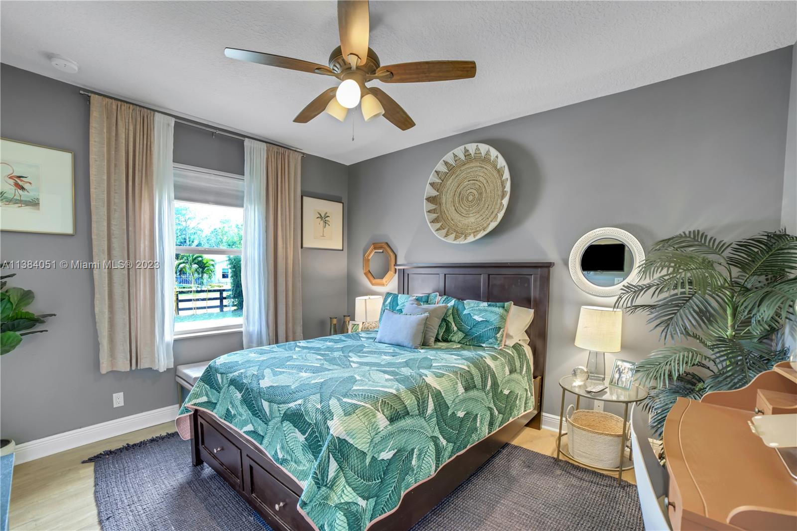 15833 Alexander Run Jupiter, FL 33478 - Photo 23 of 39 a bedroom with a bed mirror and a window