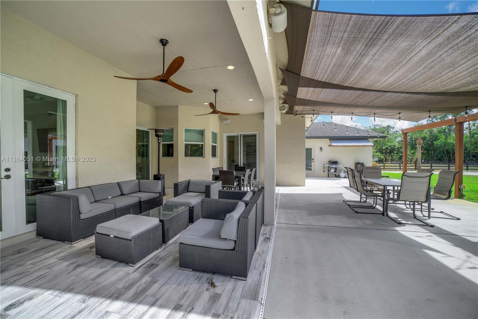 15833 Alexander Run Jupiter, FL 33478 - Photo 25 of 39 a living room with furniture and a large window