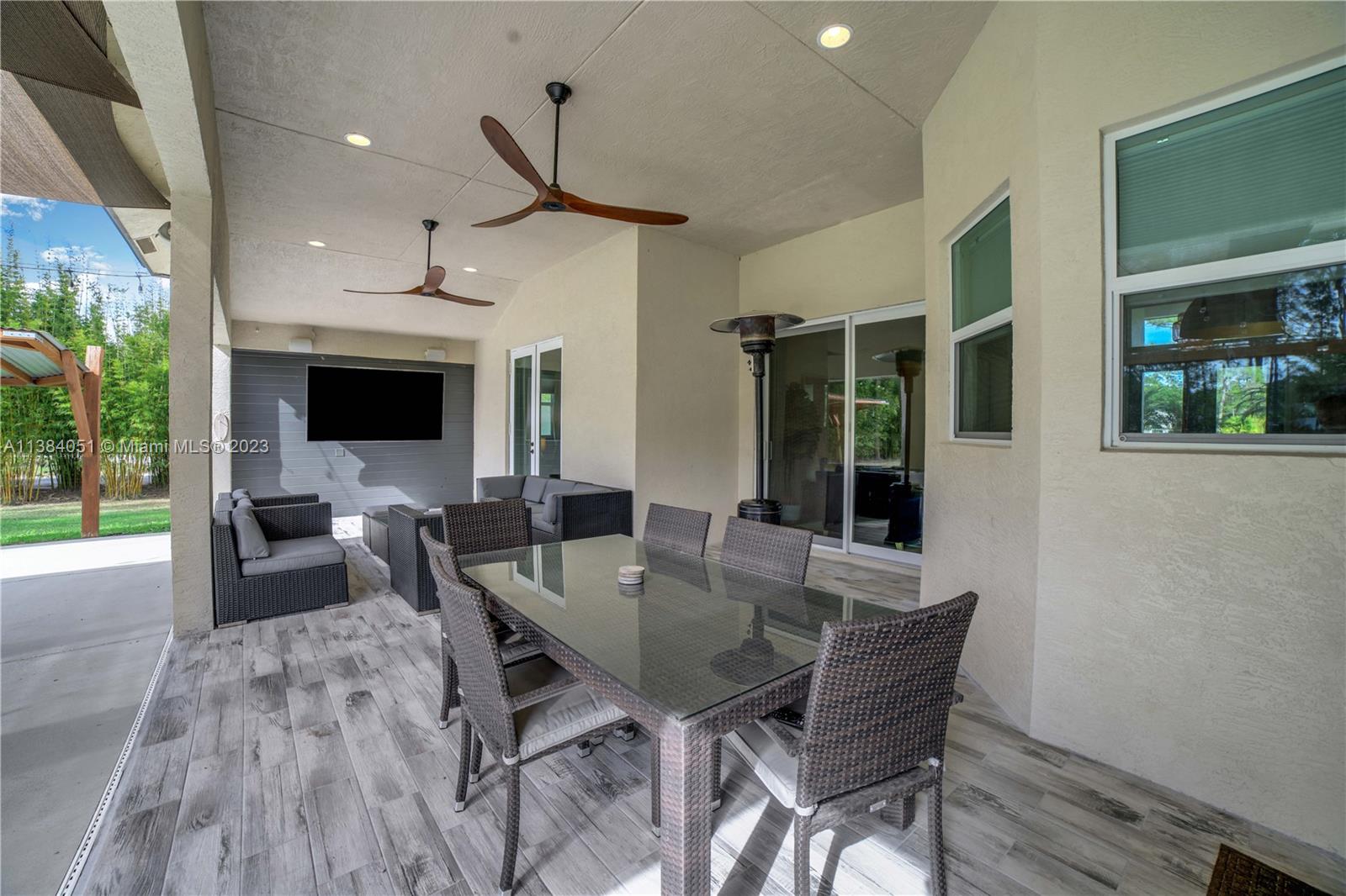 15833 Alexander Run Jupiter, FL 33478 - Photo 26 of 39 a view of a dining room with furniture window and wooden floor