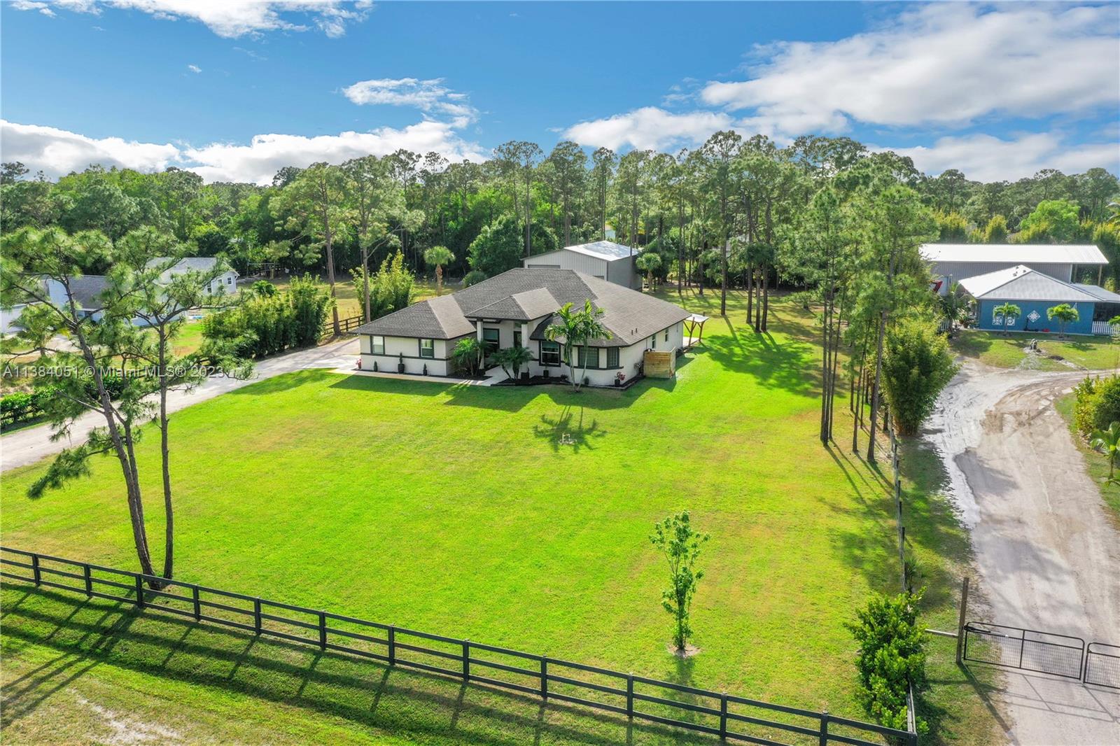 15833 Alexander Run Jupiter, FL 33478 - Photo 37 of 39 a view of a swimming pool with a yard