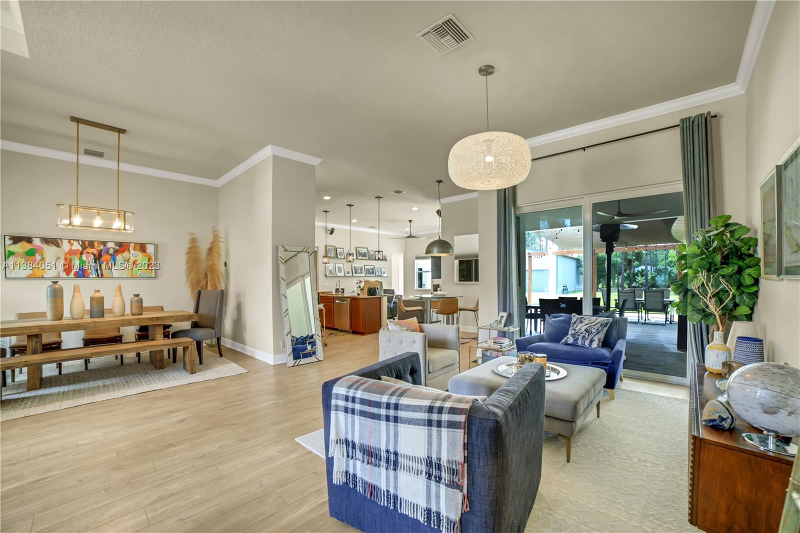 15833 Alexander Run Jupiter, FL 33478 - Photo 6 of 39 a living room with furniture and a chandelier