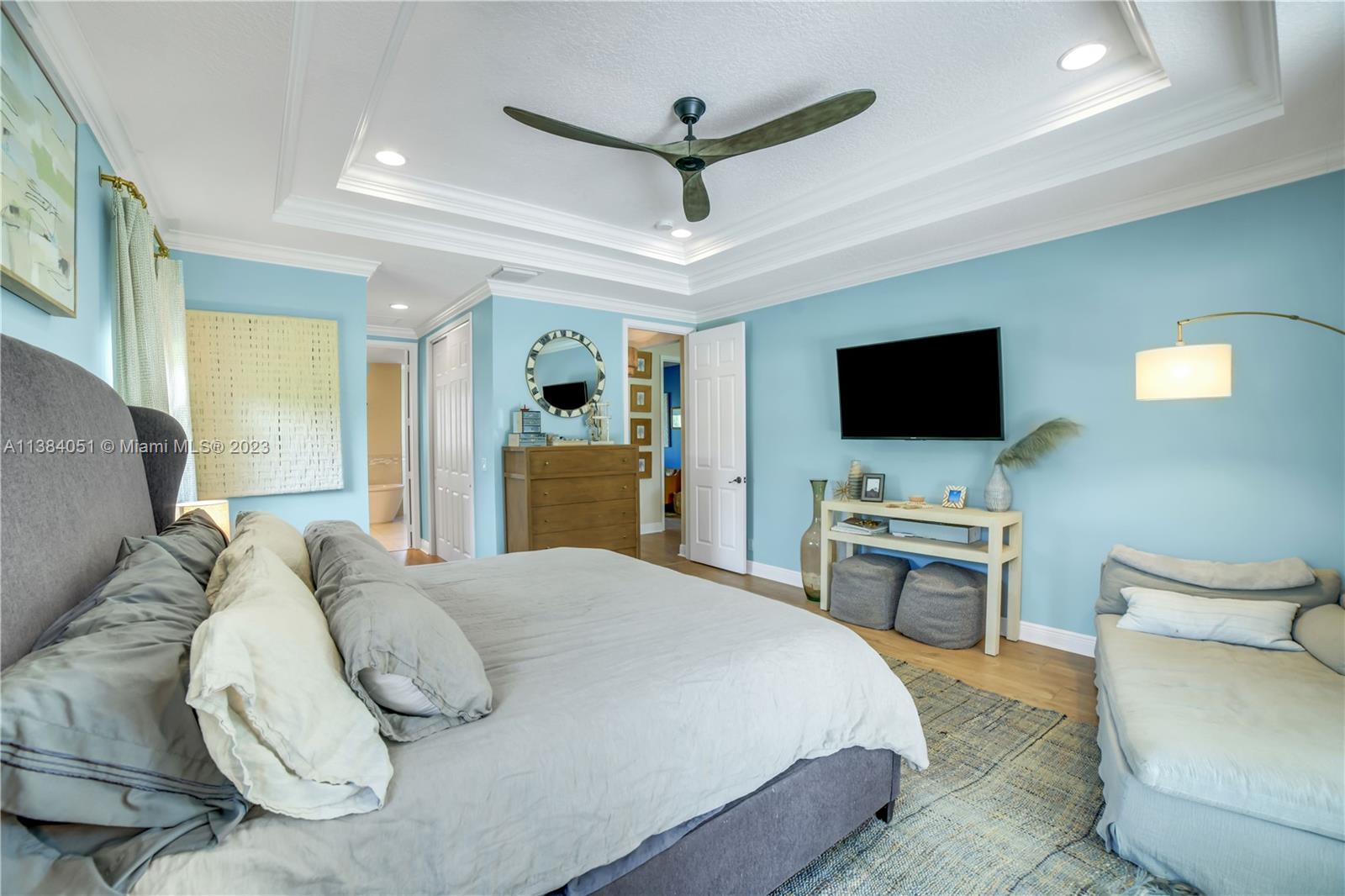 15833 Alexander Run Jupiter, FL 33478 - Photo 9 of 39 a bedroom with a bed and a flat screen tv