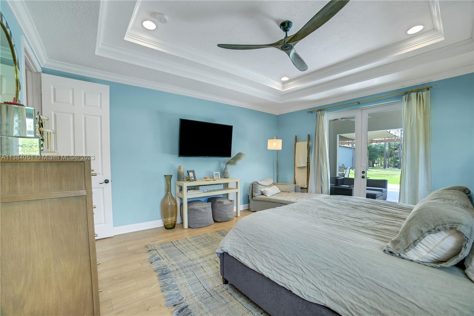 15833 Alexander Run Jupiter, FL 33478 - Photo 10 of 39 a bedroom with a bed and a flat screen tv