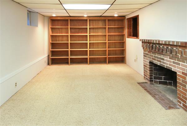 37 Bogandale Road Boston, MA 02132 - Photo 14 of 25 a view of an empty room with a fireplace and a window