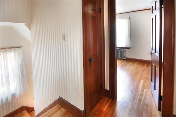 37 Bogandale Road Boston, MA 02132 - Photo 16 of 25 a view of a hallway with wooden floor and door