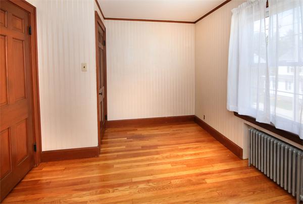 37 Bogandale Road Boston, MA 02132 - Photo 17 of 25 a view of an empty room with wooden floor and a window