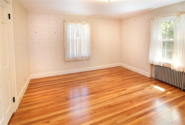 37 Bogandale Road Boston, MA 02132 - Photo 22 of 25 a view of an empty room with wooden floor and a window