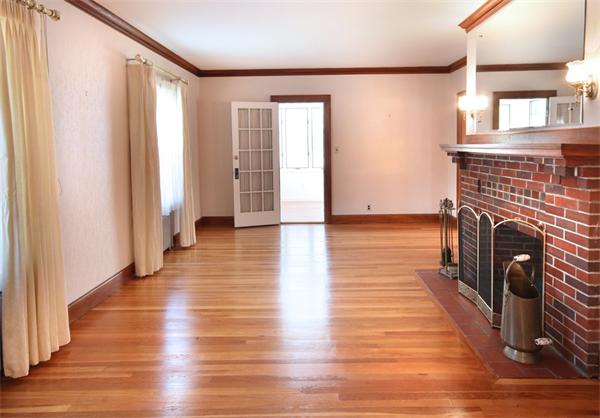 37 Bogandale Road Boston, MA 02132 - Photo 4 of 25 a view of a livingroom with wooden floor and a fireplace