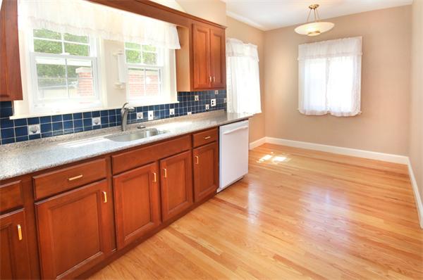 37 Bogandale Road Boston, MA 02132 - Photo 10 of 25 a kitchen with granite countertop wooden cabinets a sink and a window