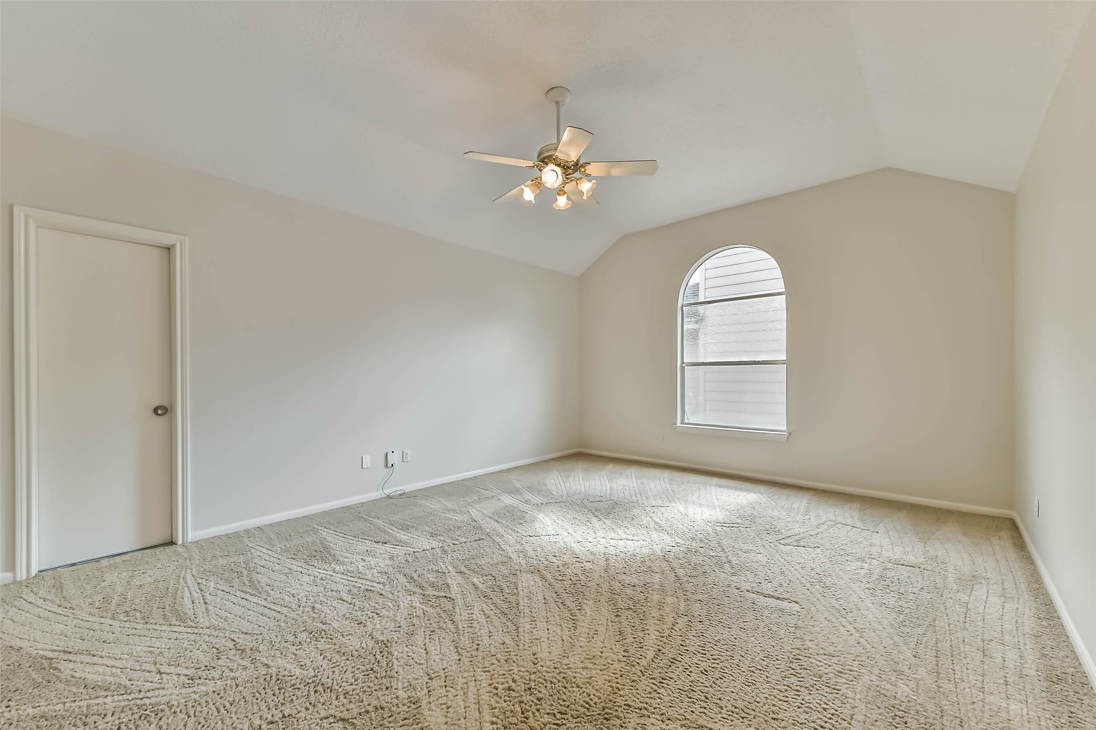 6338 Maple Spring Place Humble, TX 77346 - Photo 31 of 50 Make room for movie nights, game days or your favorite hobbies. A vaulted ceiling and arched window give this upstairs flex space an airy feel, ready for comfortable seating and a setup that suits the way you spend your downtime.