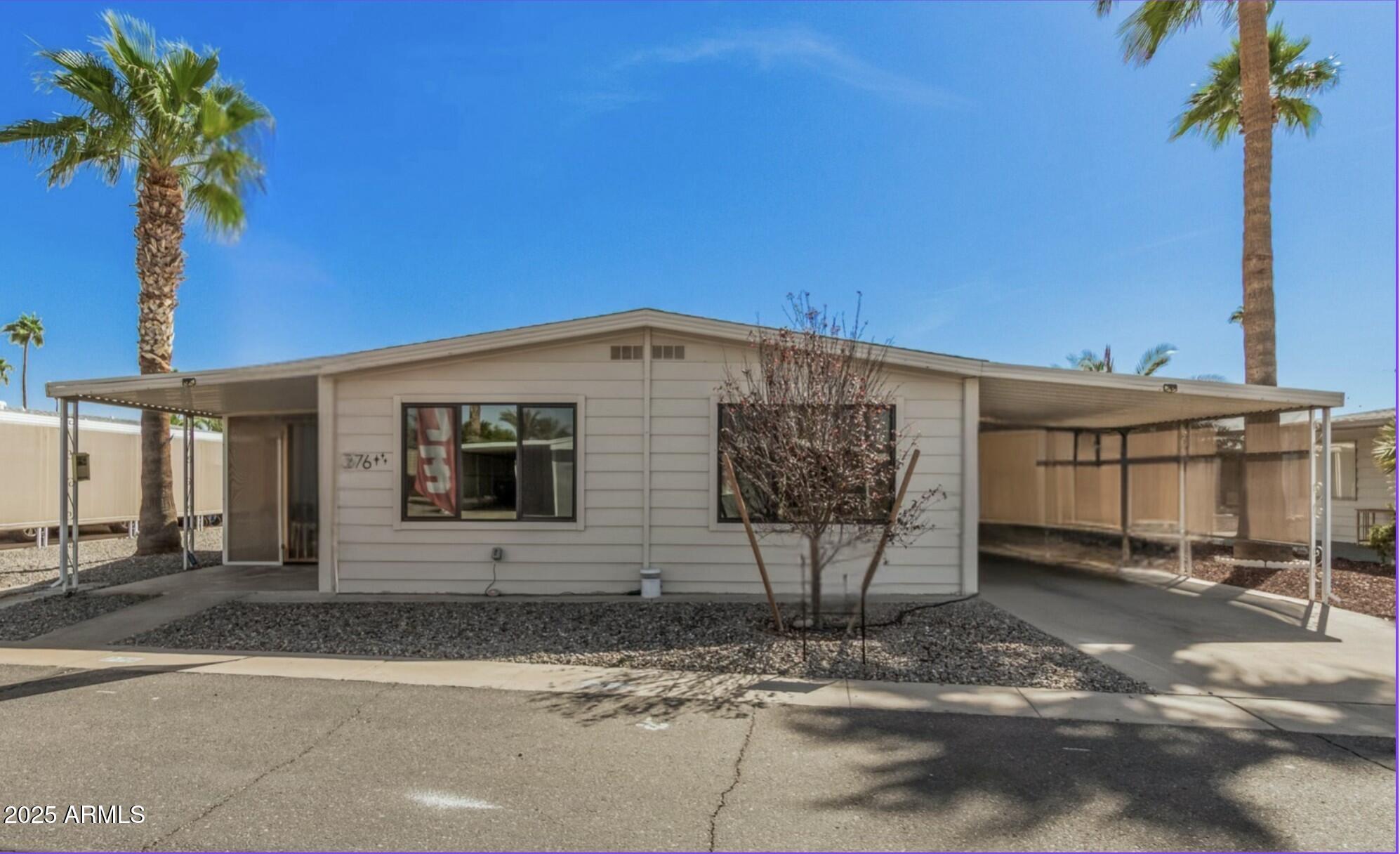 a view of a house with a backyard