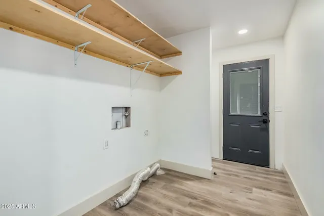 an empty room with wooden floor and closet
