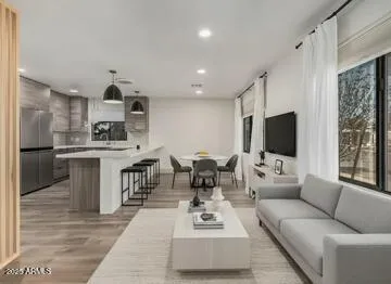 a living room with furniture flat screen tv and a fireplace