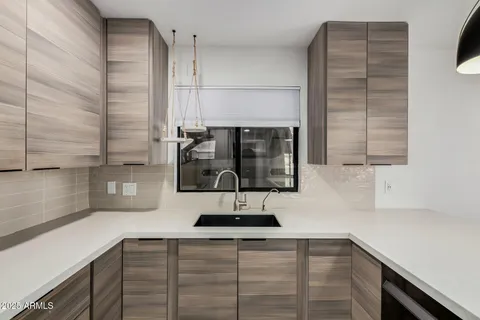 a kitchen with a sink and cabinets