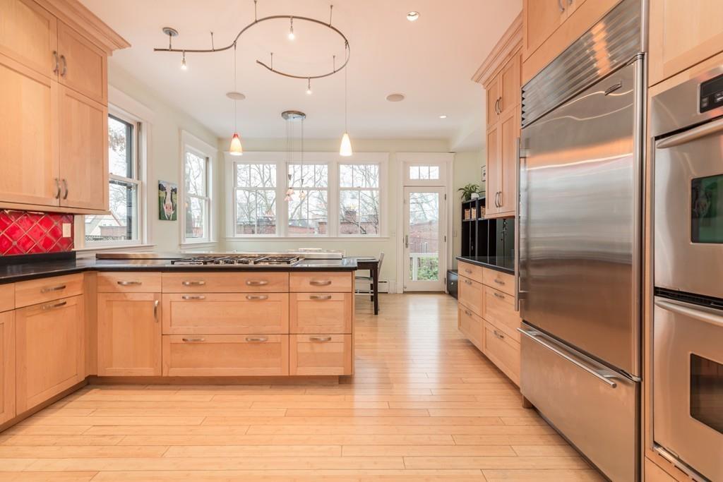 33 Naples Road Brookline, MA 02446 - Photo 12 of 31 a large kitchen with granite countertop a large counter top and stainless steel appliances