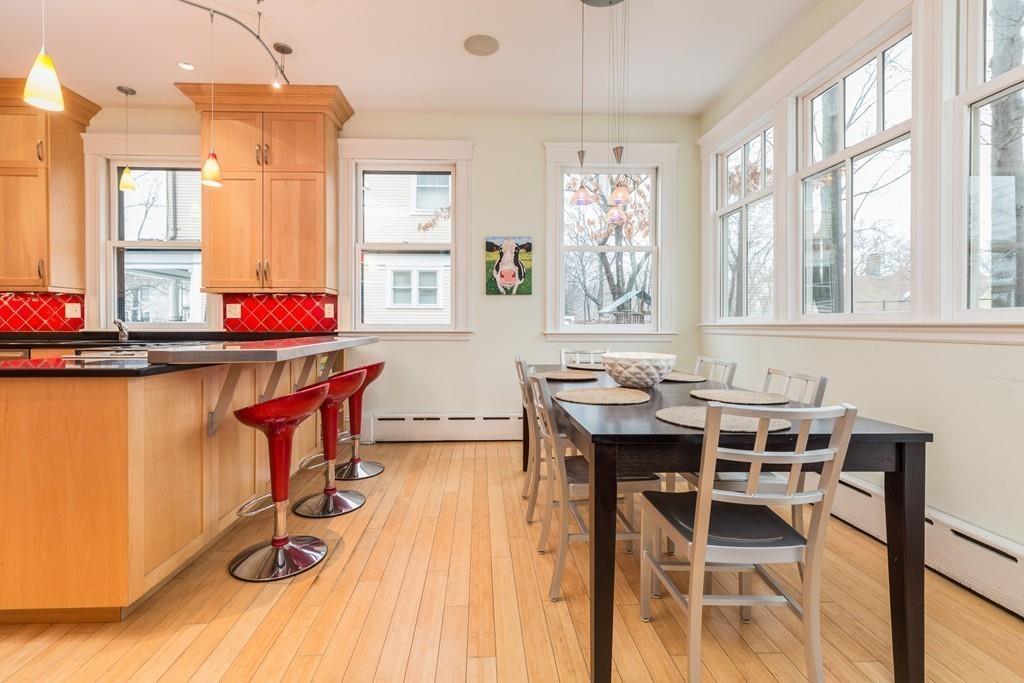 33 Naples Road Brookline, MA 02446 - Photo 13 of 31 a view of a dining room with furniture a chandelier and wooden floor