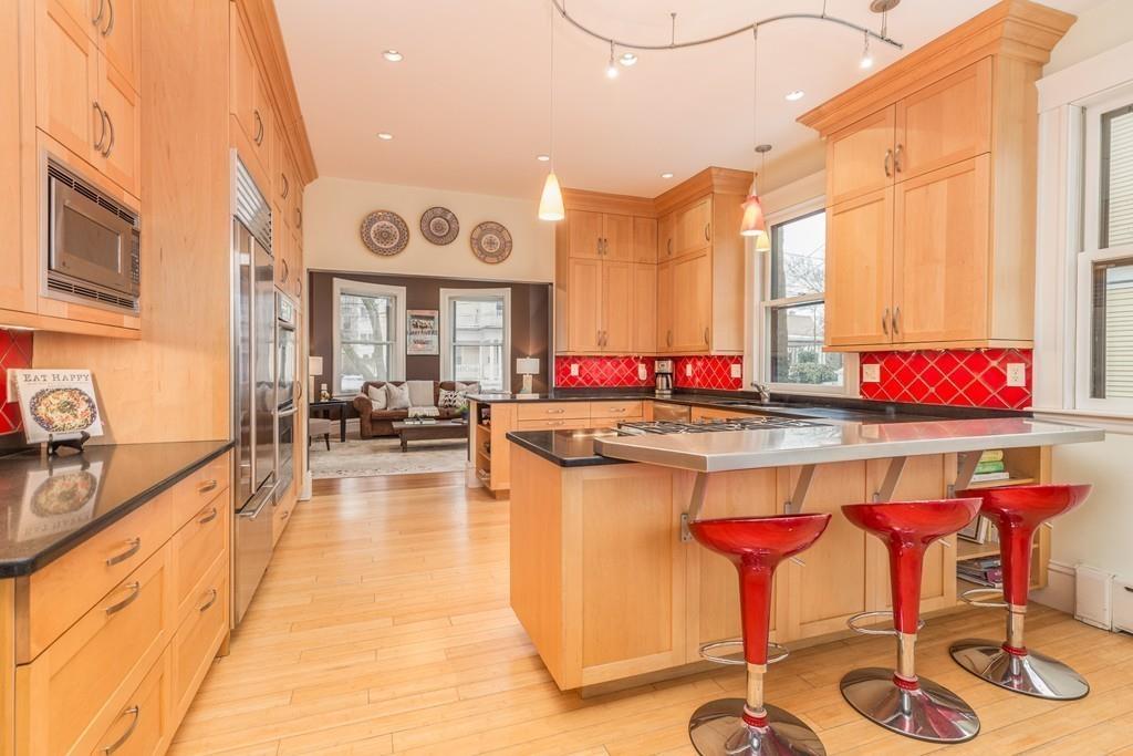 33 Naples Road Brookline, MA 02446 - Photo 14 of 31 a kitchen with a table and chairs