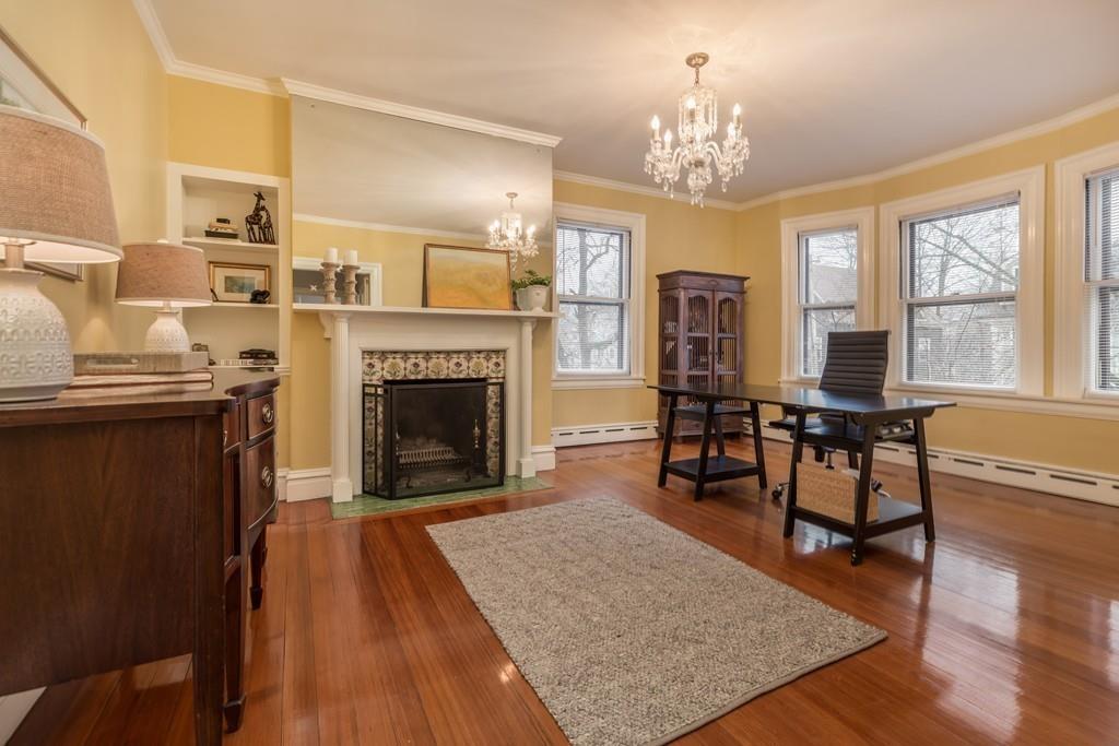 33 Naples Road Brookline, MA 02446 - Photo 17 of 31 a living room with furniture a chandelier and a fireplace