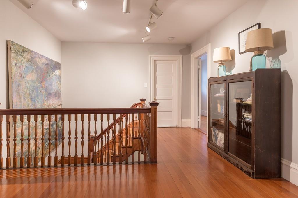 33 Naples Road Brookline, MA 02446 - Photo 23 of 31 a view of a hallway with wooden floor and windows