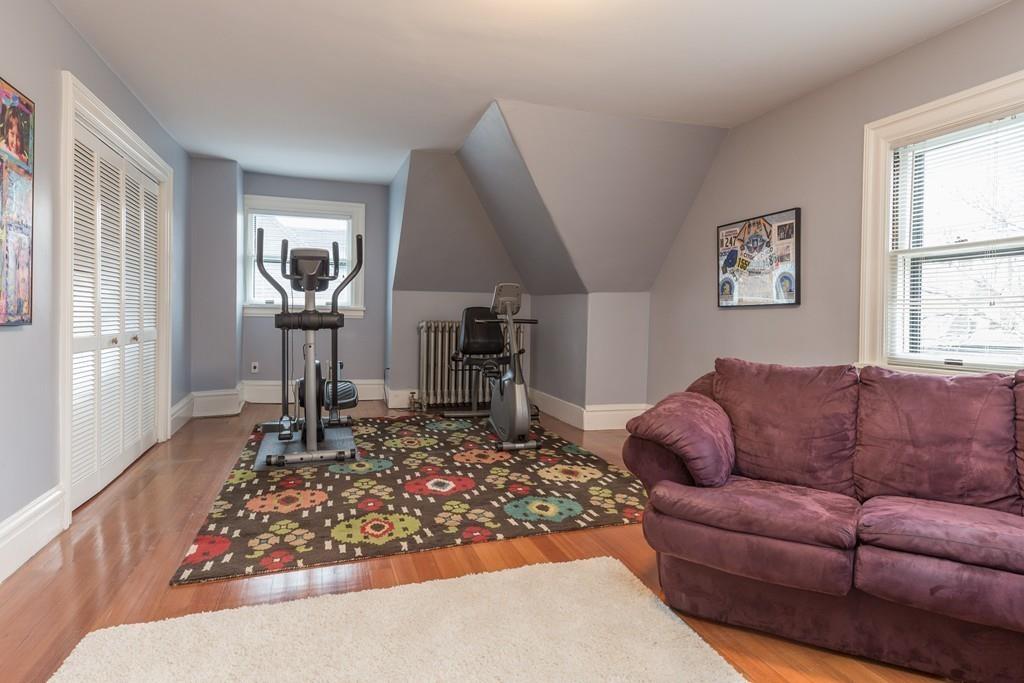 33 Naples Road Brookline, MA 02446 - Photo 27 of 31 a living room with furniture or couch and a wooden floor