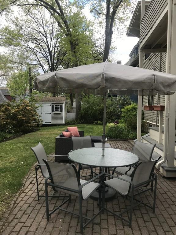 33 Naples Road Brookline, MA 02446 - Photo 29 of 31 a view of a patio with a table and chairs