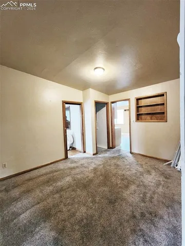a large white kitchen with a stove a sink dishwasher and a refrigerator
