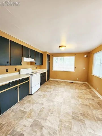 a large kitchen with kitchen island a sink stainless steel appliances and cabinets