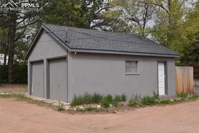 a wooden bench sitting in the middle of a yard